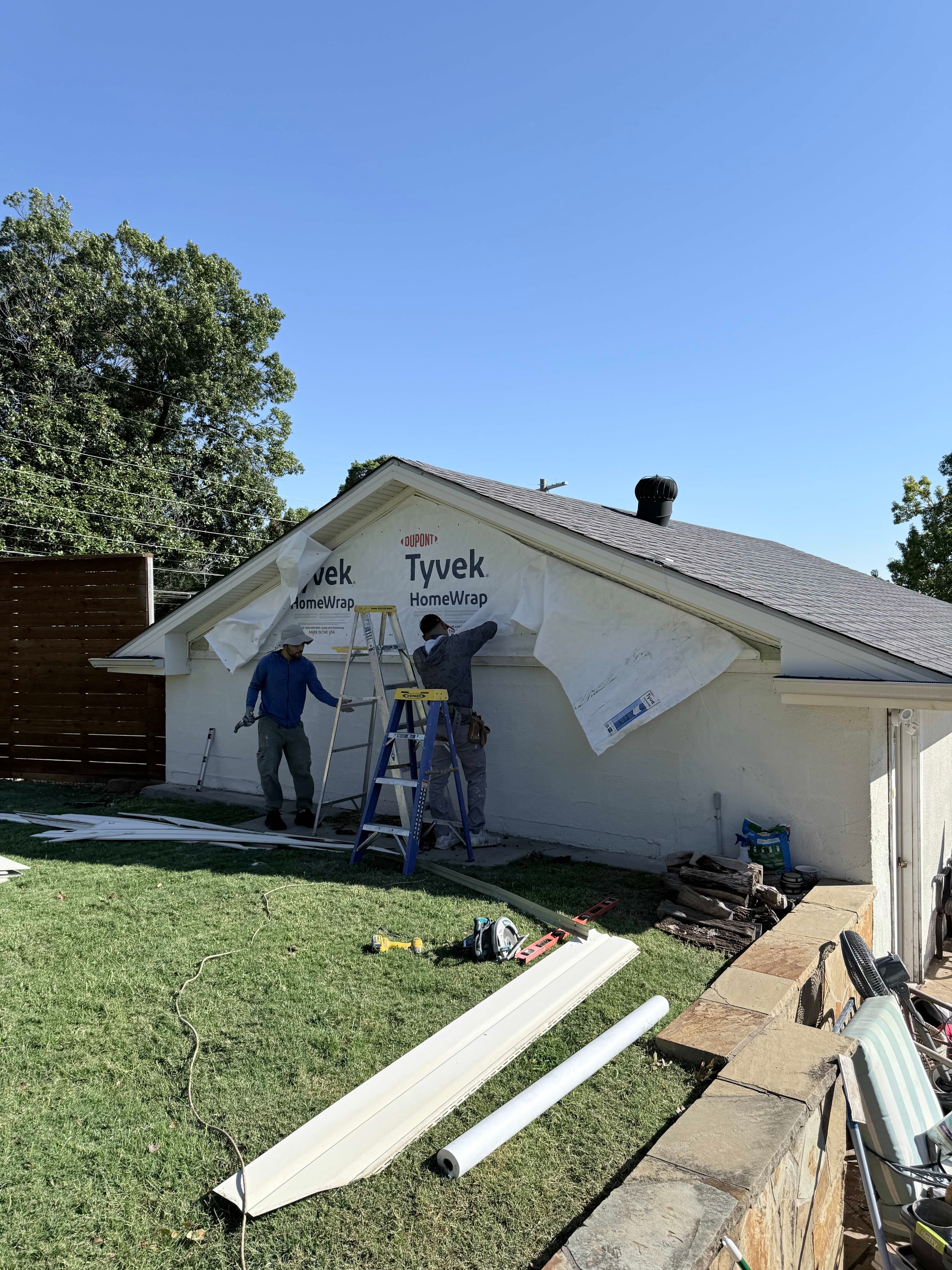 Completed exterior restoration project showing quality siding installation and trim work in Dallas