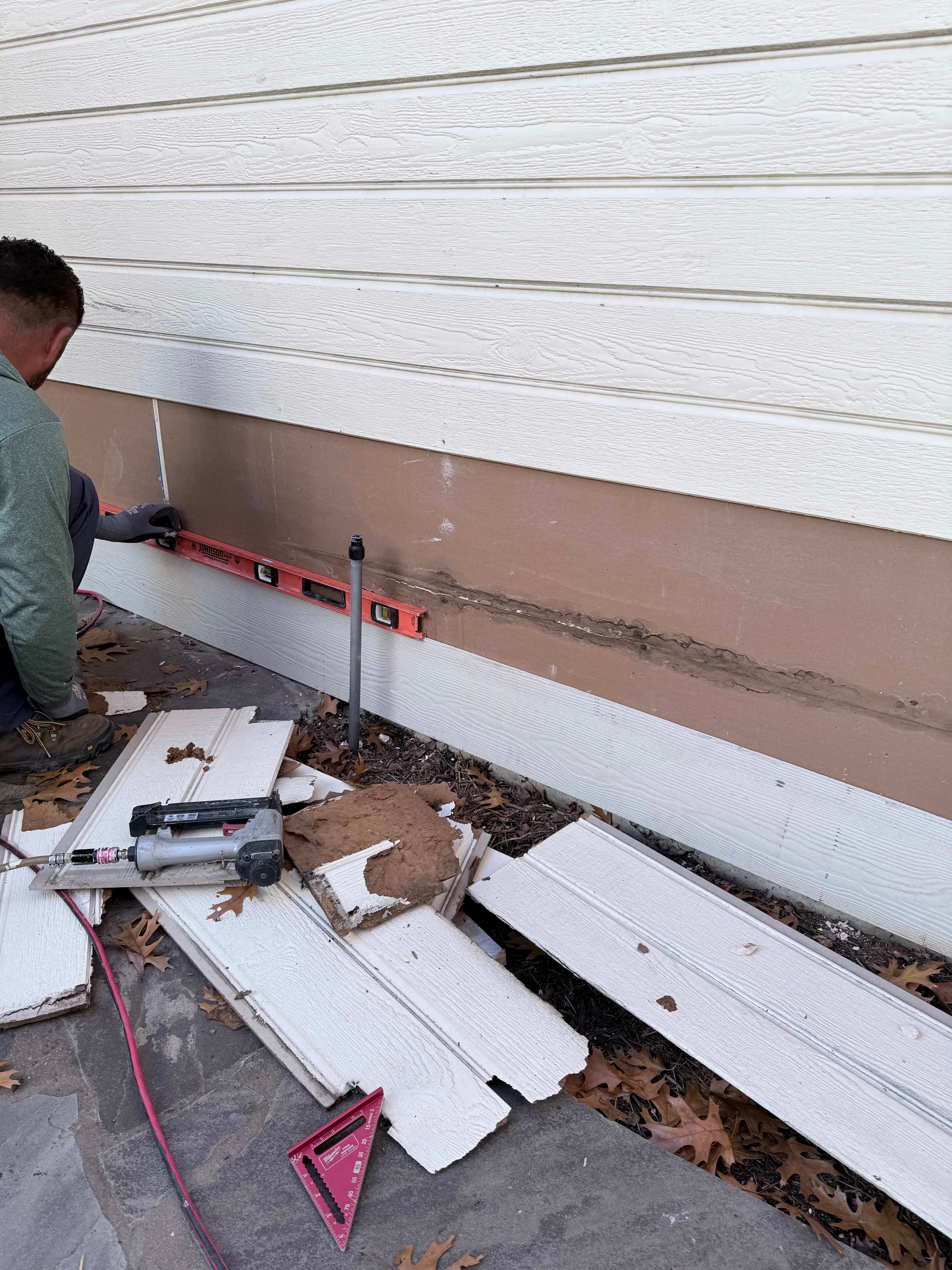Exterior restoration work in progress - window replacement and siding installation for Dallas home